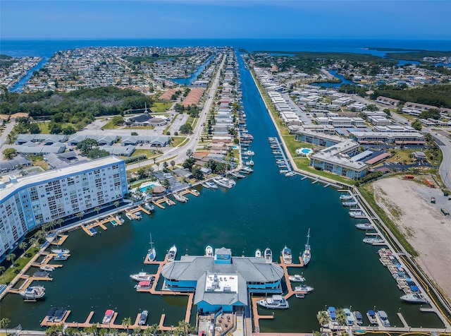 drone / aerial view of a nearby body of water and numerous boat docks