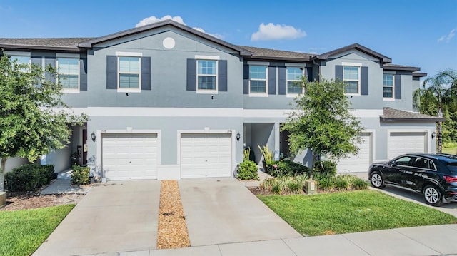 1594 Cassius St, Lutz, FL 33549 - townhome / multi-family property with stucco siding, an attached garage, and concrete driveway