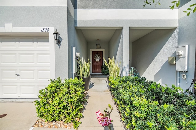 1594 Cassius St, Lutz, FL 33549 - property entrance with a garage and stucco siding