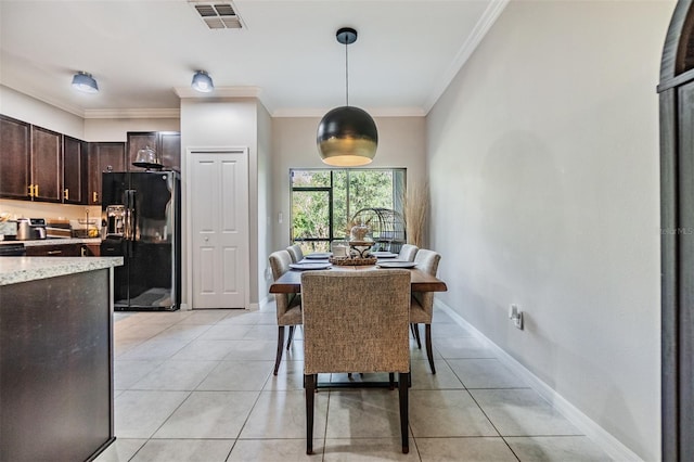 1594 Cassius St, Lutz, FL 33549 - dining room with crown molding, light tile patterned floors, and baseboards