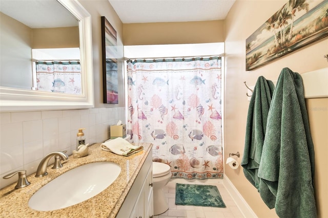 bathroom featuring vanity, tile patterned flooring, and toilet