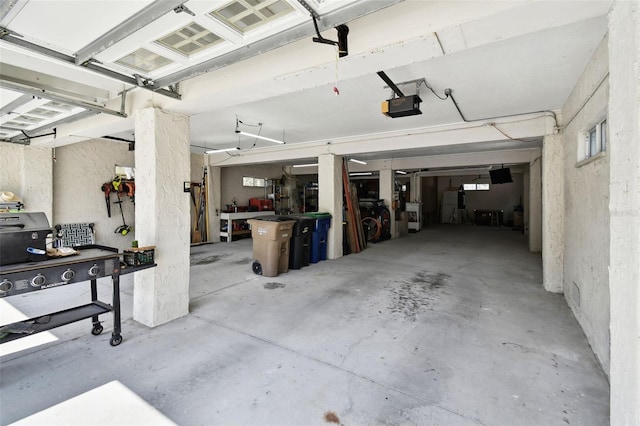 garage featuring a garage door opener and a workshop area
