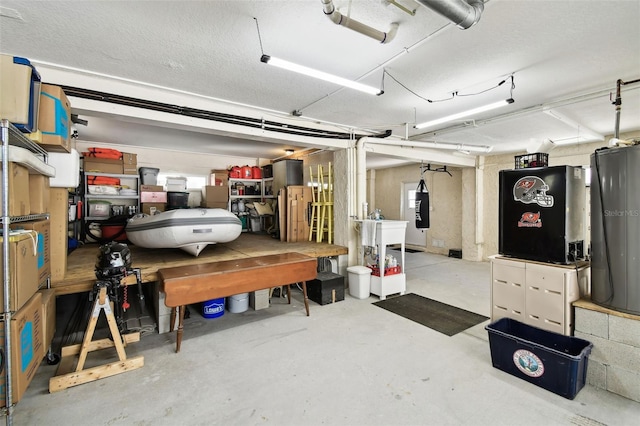 garage featuring water heater and a workshop area