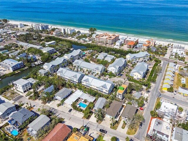 aerial view of property and surrounding area with expansive beach