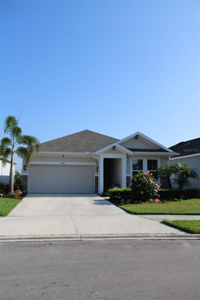 8009 Trimbelle Ter, Parrish, FL 34219 - ranch-style home with driveway, an attached garage, and stucco siding
