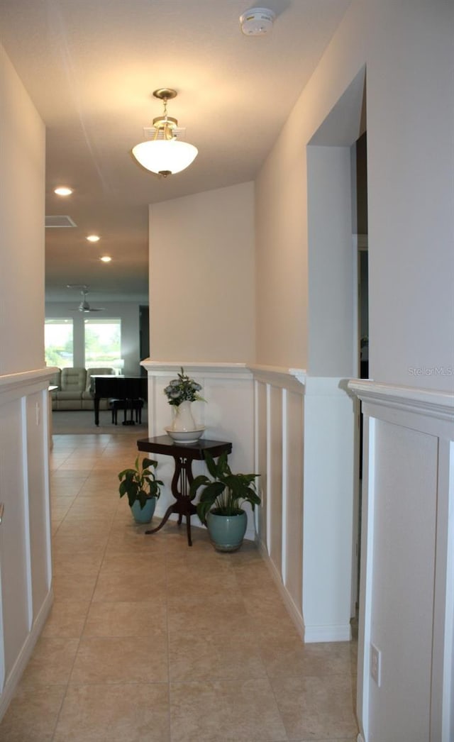 8009 Trimbelle Ter, Parrish, FL 34219 - corridor with light tile patterned floors, a wainscoted wall, recessed lighting, and a decorative wall