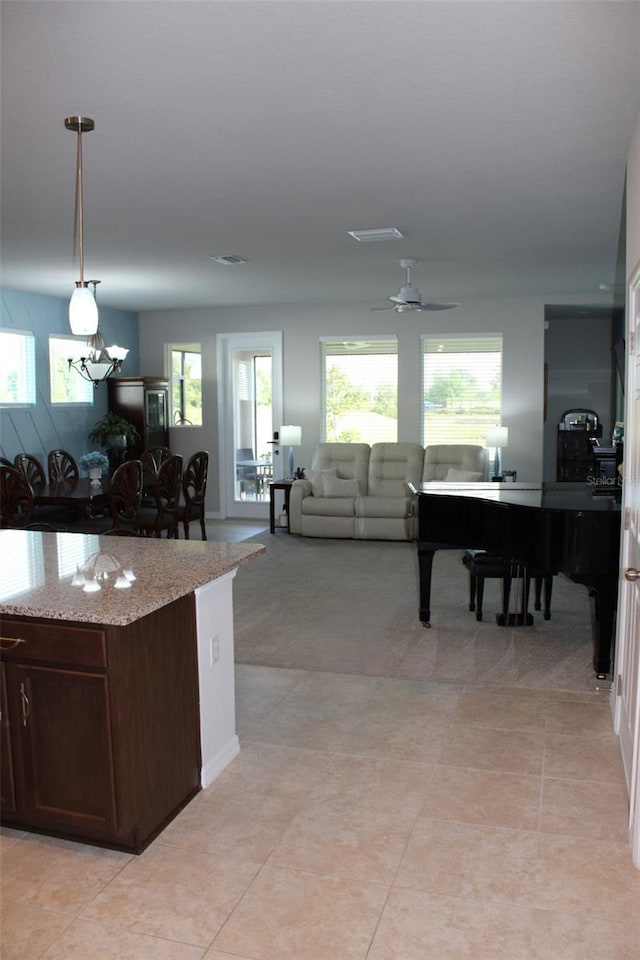 8009 Trimbelle Ter, Parrish, FL 34219 - kitchen featuring healthy amount of natural light, open floor plan, and light stone counters