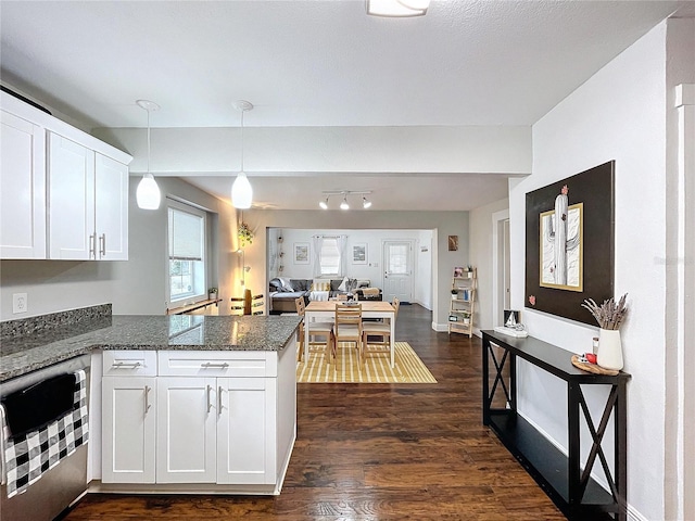 3213 E Genesee St, Tampa, FL 33610 - kitchen with dark wood-style flooring, white cabinets, a peninsula, open floor plan, and hanging light fixtures