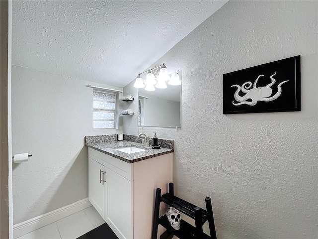 3213 E Genesee St, Tampa, FL 33610 - bathroom featuring lofted ceiling, a textured ceiling, tile patterned flooring, vanity, and a textured wall