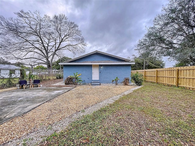 3213 E Genesee St, Tampa, FL 33610 - rear view of property featuring stucco siding and fence