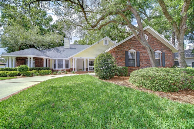 124 Barrington Dr, Brandon, FL 33511 - view of front of property featuring brick siding, a chimney, and a front lawn