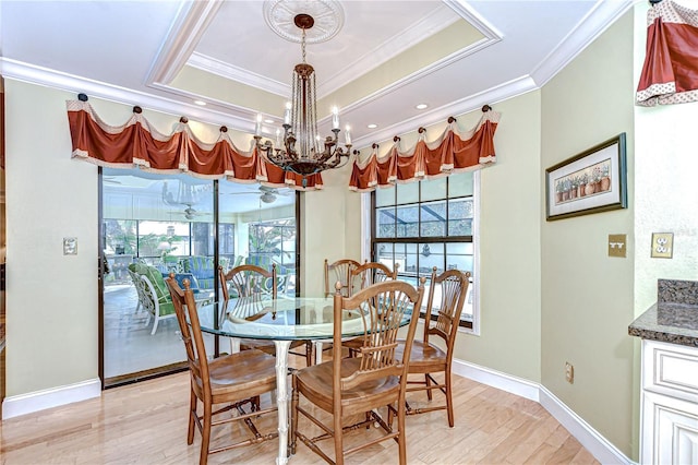 124 Barrington Dr, Brandon, FL 33511 - dining area with ornamental molding, healthy amount of natural light, light wood finished floors, a tray ceiling, and a chandelier
