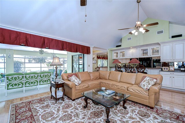 124 Barrington Dr, Brandon, FL 33511 - living room featuring a ceiling fan, high vaulted ceiling, and light wood-style flooring