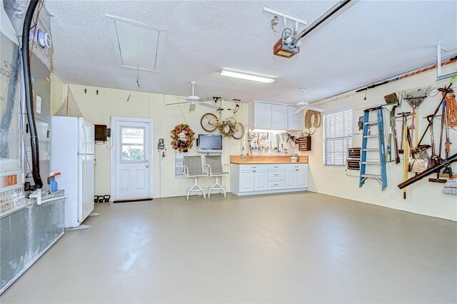 124 Barrington Dr, Brandon, FL 33511 - garage featuring freestanding refrigerator, a ceiling fan, and a garage door opener