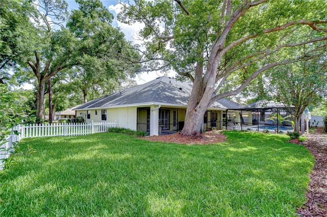 124 Barrington Dr, Brandon, FL 33511 - back of house with a lanai, a shingled roof, and stucco siding