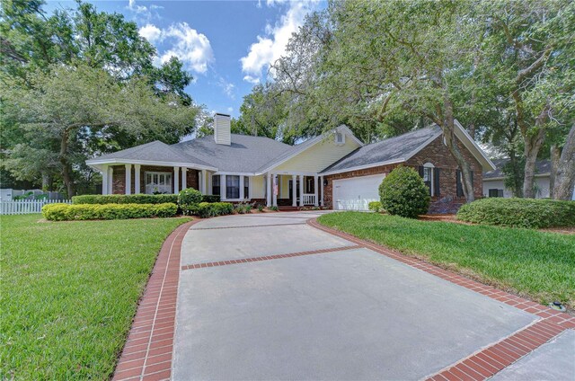 124 Barrington Dr, Brandon, FL 33511 - single story home featuring a chimney, asphalt driveway, an attached garage, and stone siding