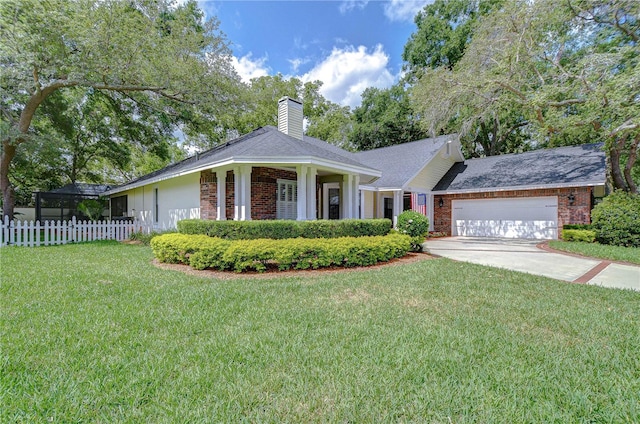 124 Barrington Dr, Brandon, FL 33511 - view of front of property featuring brick siding, a garage, a chimney, and driveway