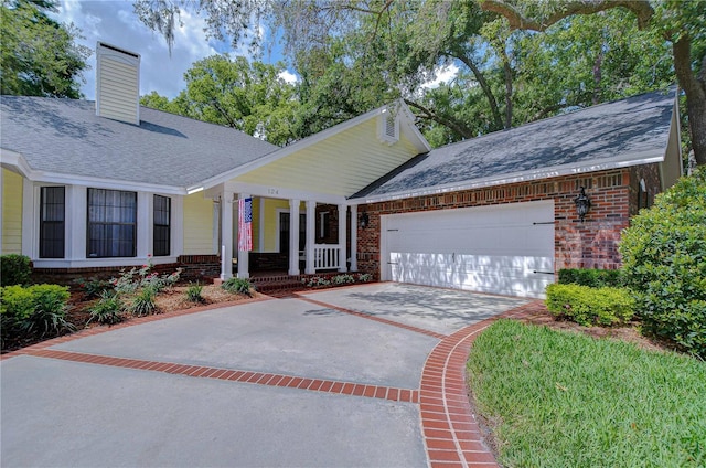 124 Barrington Dr, Brandon, FL 33511 - view of front of home with brick siding, covered porch, a garage, driveway, and roof with shingles