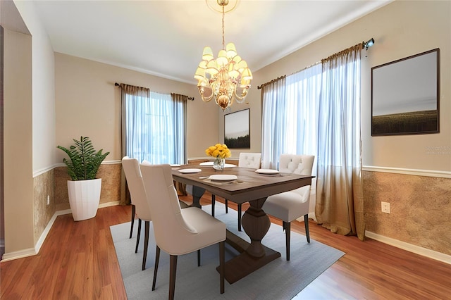 4222 Trumpworth Ct, Valrico, FL 33596 - dining area featuring a chandelier, wood finished floors, and baseboards