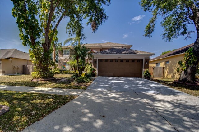 4222 Trumpworth Ct, Valrico, FL 33596 - view of front of home with an attached garage, concrete driveway, and stucco siding