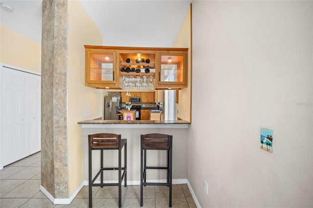 4222 Trumpworth Ct, Valrico, FL 33596 - indoor wet bar with stainless steel appliances, light tile patterned flooring, and baseboards