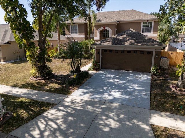 4222 Trumpworth Ct, Valrico, FL 33596 - view of front of home featuring stucco siding, a garage, and concrete driveway