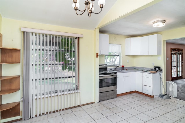 kitchen with electric range, a sink, white cabinets, a chandelier, and light tile patterned floors