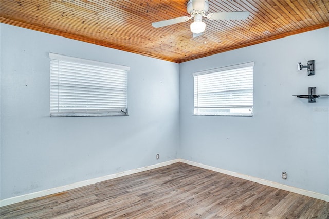 unfurnished room with ornamental molding, ceiling fan, baseboards, and wood finished floors
