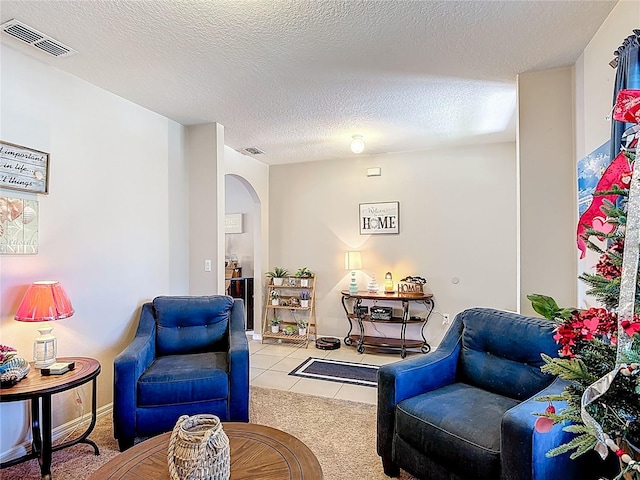 159 Lazy Willow Dr, Davenport, FL 33897 - tiled living area featuring arched walkways and a textured ceiling