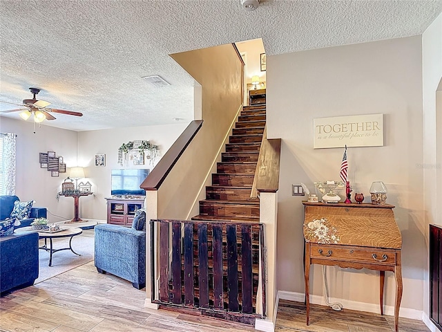 159 Lazy Willow Dr, Davenport, FL 33897 - staircase with ceiling fan, a textured ceiling, and wood finished floors