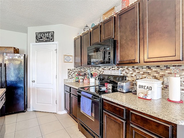 159 Lazy Willow Dr, Davenport, FL 33897 - kitchen featuring black appliances, light tile patterned floors, light countertops, backsplash, and dark brown cabinetry