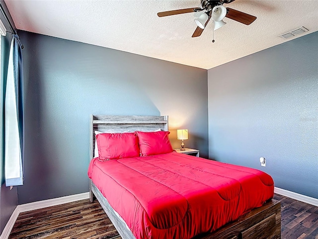 159 Lazy Willow Dr, Davenport, FL 33897 - bedroom with wood finished floors, baseboards, a ceiling fan, and a textured ceiling