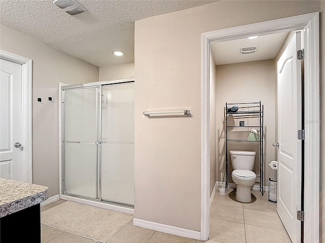 159 Lazy Willow Dr, Davenport, FL 33897 - full bath with a shower stall, tile patterned floors, toilet, a textured ceiling, and baseboards