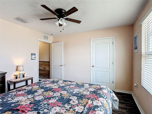 159 Lazy Willow Dr, Davenport, FL 33897 - bedroom featuring dark wood-style floors, a textured ceiling, baseboards, and a ceiling fan