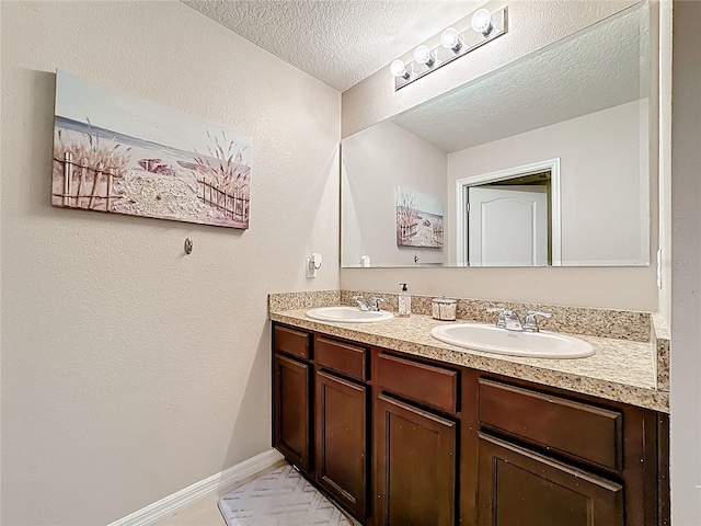 159 Lazy Willow Dr, Davenport, FL 33897 - full bath featuring double vanity, a textured ceiling, and baseboards