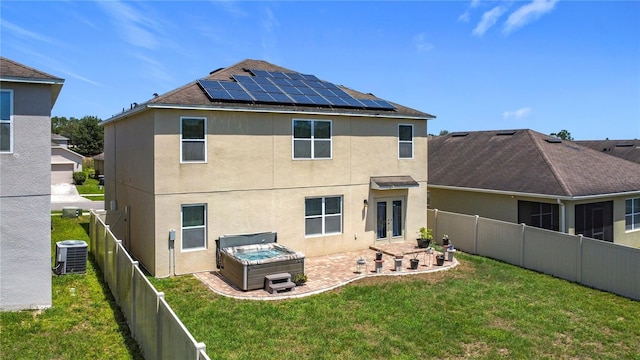 159 Lazy Willow Dr, Davenport, FL 33897 - back of property with a patio, stucco siding, roof mounted solar panels, french doors, and a hot tub