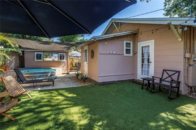 back of house featuring an outdoor structure and a patio area