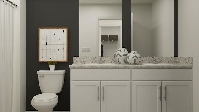 bathroom featuring toilet and double vanity