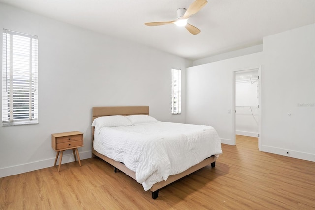 5628 Terrain De Golf Dr, Lutz, FL 33558 - bedroom featuring multiple windows, light wood finished floors, and baseboards