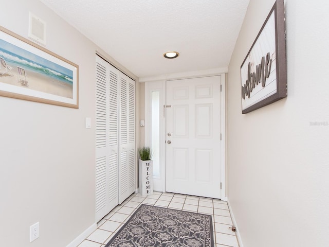 640 Bayway Blvd Unit 302, Clearwater Beach, FL 33767 - doorway to outside featuring baseboards, light tile patterned floors, a textured ceiling, and recessed lighting