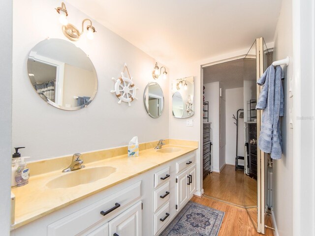 640 Bayway Blvd Unit 302, Clearwater Beach, FL 33767 - bathroom featuring wood finished floors and double vanity