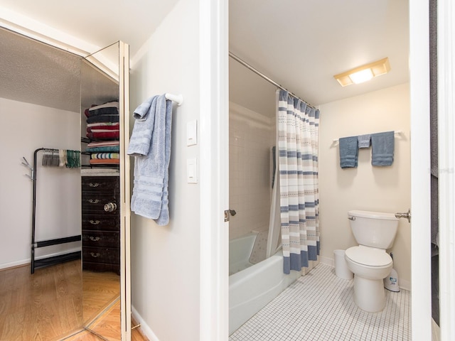640 Bayway Blvd Unit 302, Clearwater Beach, FL 33767 - bathroom with toilet, baseboards, and shower / tub combo with curtain