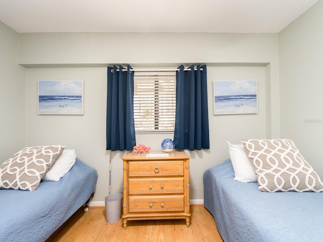 640 Bayway Blvd Unit 302, Clearwater Beach, FL 33767 - bedroom featuring wood finished floors and baseboards