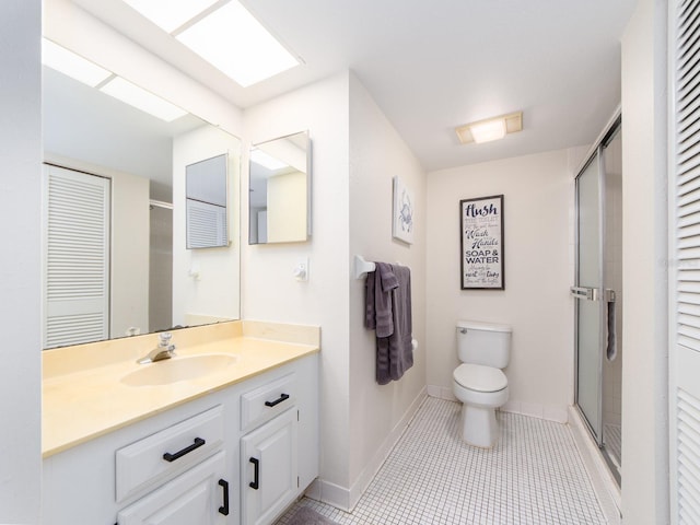640 Bayway Blvd Unit 302, Clearwater Beach, FL 33767 - bathroom with a shower stall, toilet, vanity, and baseboards