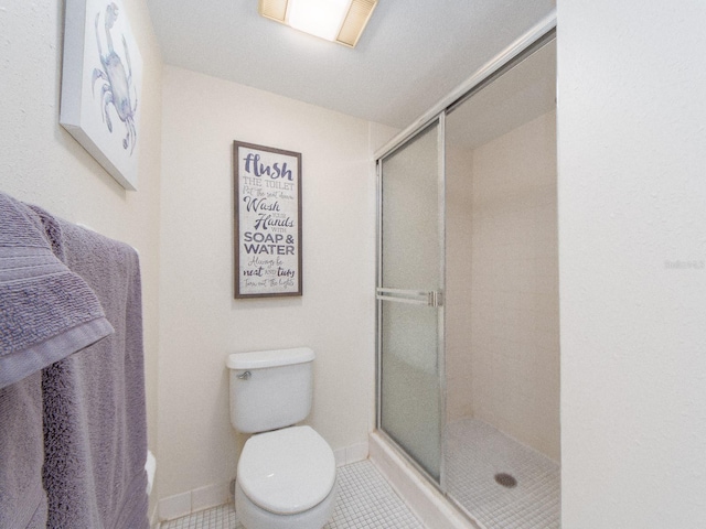 640 Bayway Blvd Unit 302, Clearwater Beach, FL 33767 - full bathroom featuring a stall shower, toilet, baseboards, and tile patterned flooring