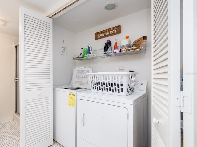 640 Bayway Blvd Unit 302, Clearwater Beach, FL 33767 - clothes washing area with washer and dryer and light tile patterned floors