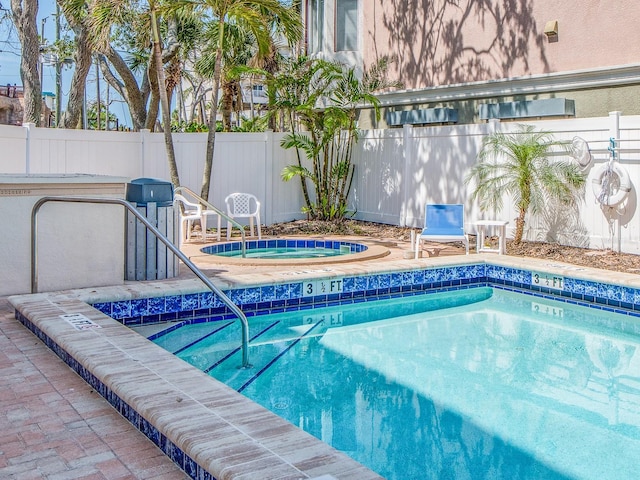 640 Bayway Blvd Unit 302, Clearwater Beach, FL 33767 - view of swimming pool with an in-ground hot tub, fence, and a swimming pool