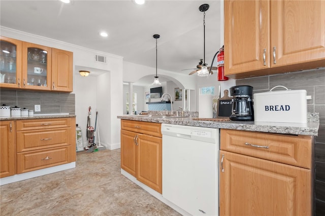 kitchen with dishwasher, a sink, ceiling fan, decorative backsplash, and glass insert cabinets