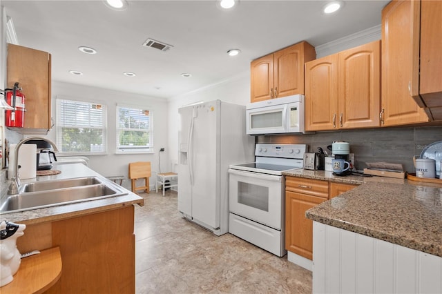 kitchen featuring white appliances, a sink, tasteful backsplash, and recessed lighting