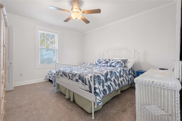 carpeted bedroom with crown molding, baseboards, and ceiling fan